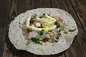 A plate with fresh chicken and salad tortilla wraps Ã‘â€ 